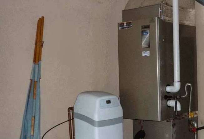 Experienced technician installing a new furnace system in Delano