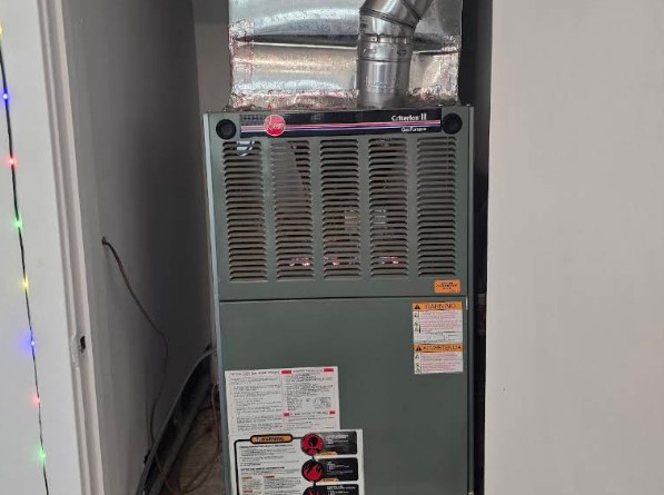 Technician repairing a furnace during a scheduled visit in Delano, CA